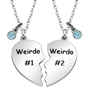 Detailed view of silver heart puzzle pendants engraved with Weirdo and blue rhinestones