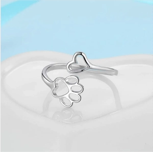 Adjustable silver open ring featuring a hollow heart and a delicate pet paw print design
