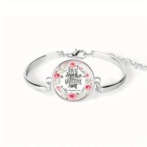 Macro detail of silver Bible verse bracelet with rose wreath and Give Thanks text