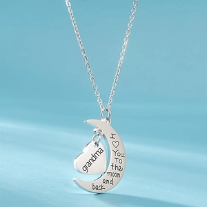 Silver crescent moon and heart necklace with Grandma engraving on light blue background