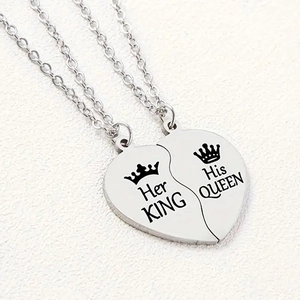 Detail of puzzle heart pendants with Her KING and His QUEEN engraved on stainless steel