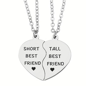 Detail of puzzle heart necklaces for best friends with engraved text on stainless steel