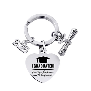 Macro detail of 2025 graduation keychain with engraved heart and graduate scroll charms
