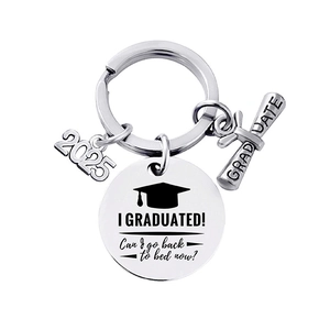 Close-up of 2025 graduation keychain with scroll charm and funny engraved round metal tag