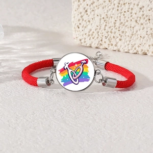 Detail of red woven lesbian pride bracelet with rainbow flag and female symbols glass charm