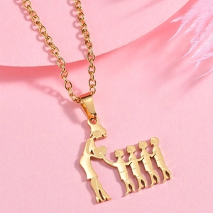 Macro detail of gold family necklace featuring a mother and four children silhouette pendant