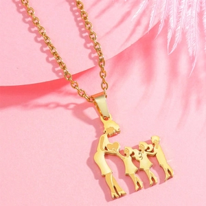 Macro detail of golden family silhouette pendant showing mother and three children