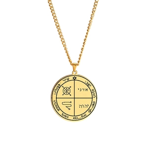 Macro detail of gold stainless steel seal of Solomon talisman pendant with Hebrew symbols