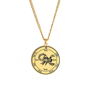 Macro shot of gold stainless steel seal pendant with scorpion and Hebrew engraving
