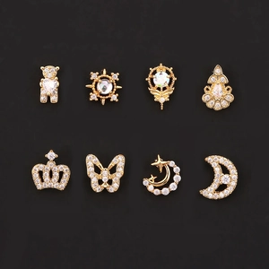Detailed close-up of eight gold-plated cz stud earrings with teddy bear and crown designs