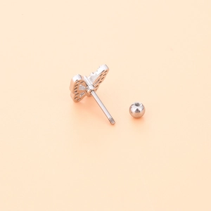 Macro shot of silver butterfly stud earring with sparkling cubic zirconia and ball back screw