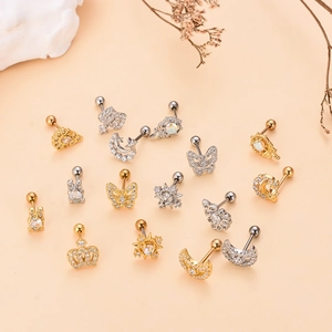 Golden and silver ear piercing jewelry collection with crown, moon and star designs