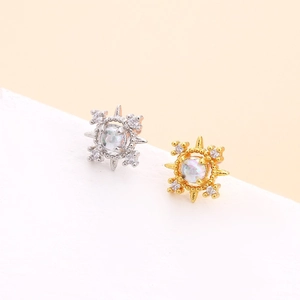 Star-shaped crystal stud earrings in gold and silver finish with opal stones