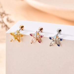 Macro view of star-shaped stainless steel ear studs with colorful zircon stones