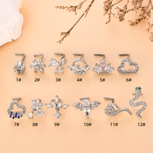 Set of 12 silver-toned L-shaped nose studs featuring zircon butterflies and crown shapes