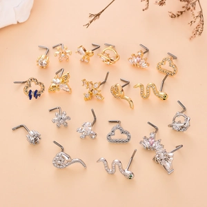 Detailed macro view of L-shaped stainless steel nose studs with assorted CZ crystal shapes