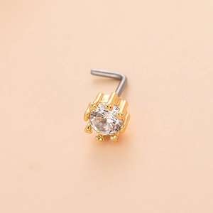 L-shaped gold nose stud with a multi-prong set clear cubic zirconia on a pink background