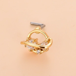 Macro view of a gold-plated L-shaped nose stud with three sparkling zircon stones