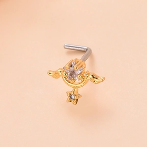 Detailed macro view of a star and moon wing nose stud with zircon inlays in gold plating