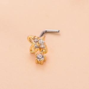 Detail of flower nose stud with gold plating, sparkling zircons, and a dangling crystal charm