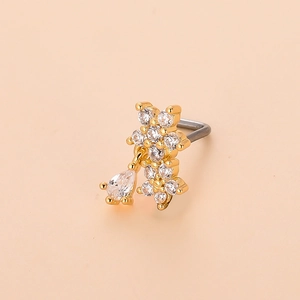 Detailed view of L-shaped gold nose stud with floral zircon clusters and pear-shaped pendant