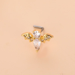 Detail macro view of L-shaped gold bat nose stud with sparkling teardrop zircon stones