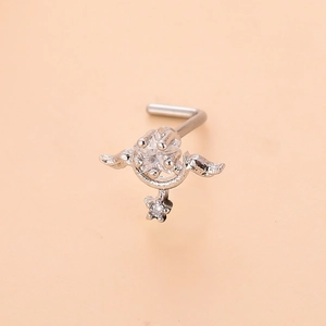 Macro shot of L-shaped silver nose stud with star zircon, wings, and hanging star charm