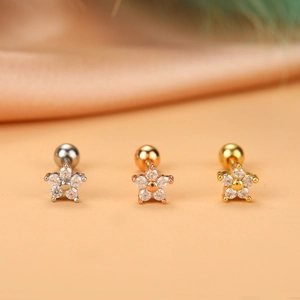 Macro shot of three flower zircon ear studs in silver, gold, and rose gold stainless steel
