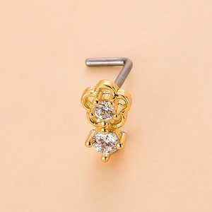 Detailed macro view of an L-shaped gold nose stud with flower design and cubic zirconia