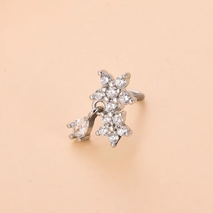 Close-up of floral nose stud with sparkling cubic zirconia and a teardrop-shaped gemstone