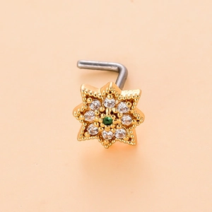 Detailed close-up of a gold L-shaped nose stud with star design and green zircon inlay