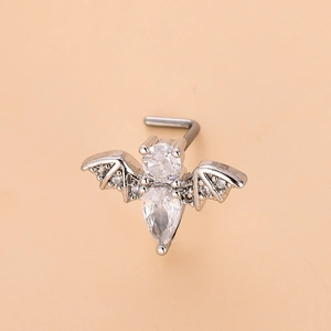 Detail of bat-shaped stainless steel L-bend nose stud with sparkling cubic zirconia stones