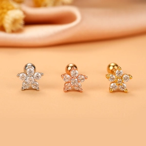 Detailed close-up of six-petal flower cartilage studs in silver, gold, and rose gold finishes