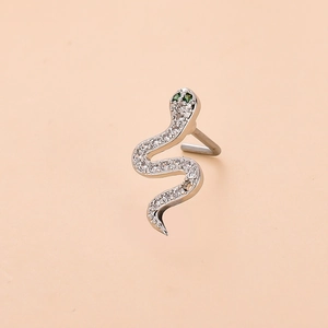 Detail of silver snake nose stud with sparkling white zircons and green gemstone eyes