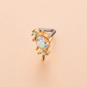 Detailed macro view of L-shaped gold nose stud with iridescent opal and blue zircon accents