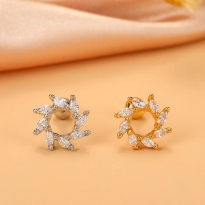 Macro detail of silver and gold wreath earrings with marquise-cut zircon and ball back
