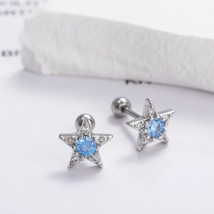 Detailed close-up of star stud earrings featuring blue zircon centers and screw ball backs