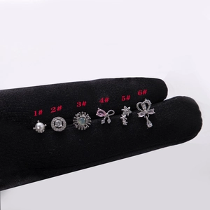 Fashion zircon bow and teardrop pendant ear studs collection on black velvet background
