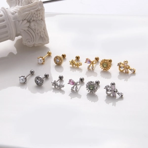 Bow and teardrop zircon stud earrings set with spiral backings in gold and silver finish