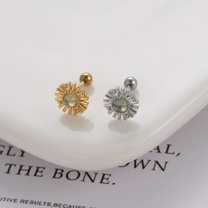 Detail of sunburst stud earrings with green stones and ball screw backs in gold and silver