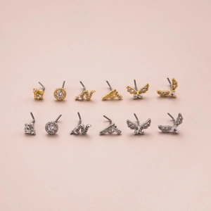 L-shaped stainless steel nose studs with cubic zirconia in pistol, butterfly and crown shapes