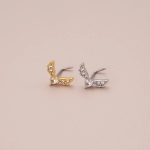 Detail of L-shaped nose studs featuring winged heart design with sparkling zircons