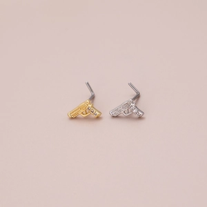 L-shaped pistol nose studs in gold and silver with micro-pave cubic zirconia details