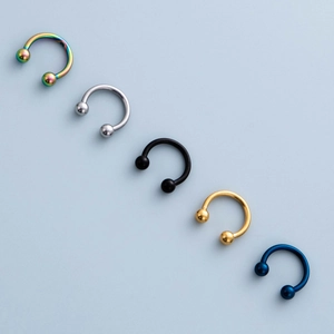 Five-piece set of stainless steel horseshoe rings in assorted metallic colors for piercing