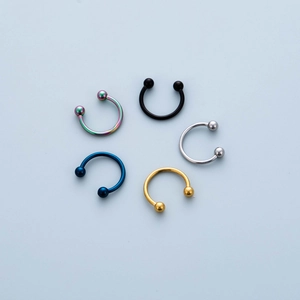 Five-piece set of stainless steel horseshoe barbells in multiple metallic finishes for body piercing