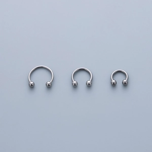 Three sizes of stainless steel circular barbells with smooth polished finish and round beads