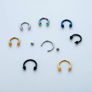 Detail showing 316 stainless steel horseshoe rings with threaded spikes in five colors