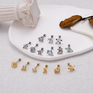 Detailed close-up of titanium steel cartilage studs with celestial opal and zircon designs