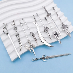 Macro view of ten vintage silver alloy sword charms with detailed fantasy engravings