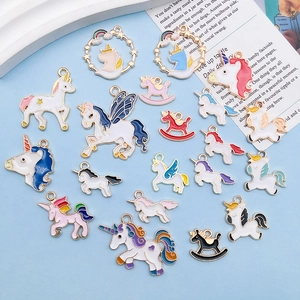 Macro view of colorful enamel unicorn charms and horse pendants for DIY jewelry crafting